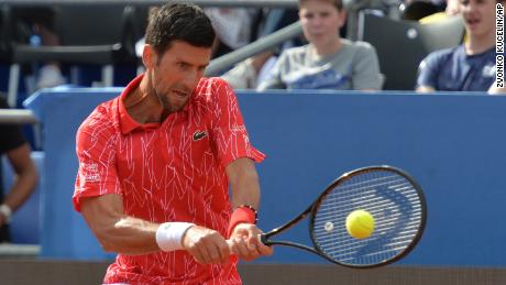 Serbia&#39;s Novak Djokovic returns the ball during an exhibition tournament in Zadar, Croatia, Sunday, June 21, 2020. Tennis player Grigor Dimitrov says he has tested positive for COVID-19 and his announcement led to the cancellation of an exhibition event in Croatia where Novak Djokovic was scheduled to play on Sunday. (AP Photo/Zvonko Kucelin)