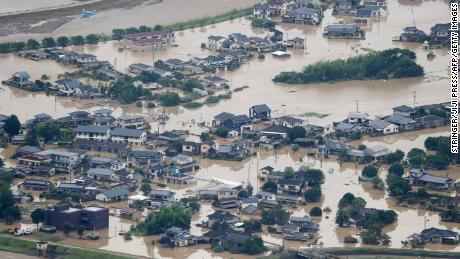 This picture shows inundated houses due to heavy rain in Hitoyoshi, Kumamoto prefecture on July 4, 2020. - Fourteen people were feared dead at a nursing home in western Japan on July 4 as record rainfall triggered massive floods and landslides, forcing authorities to issue evacuation advisories for more than 200,000 residents. (Photo by STR / JIJI PRESS / AFP) / Japan OUT (Photo by STR/JIJI PRESS/AFP via Getty Images)